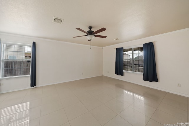 unfurnished room featuring crown molding, plenty of natural light, and ceiling fan