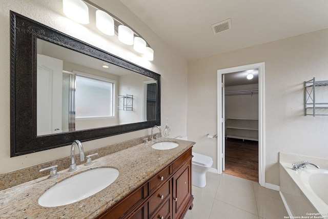 full bathroom featuring vanity, tile patterned floors, shower with separate bathtub, and toilet