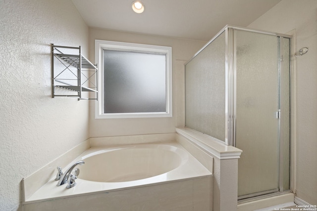 bathroom featuring separate shower and tub