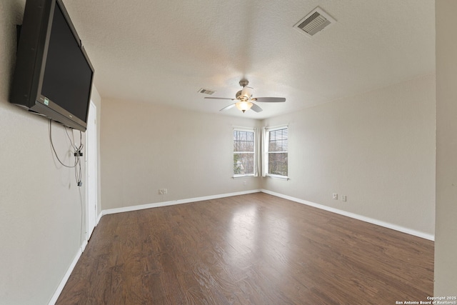 unfurnished room featuring ceiling fan, dark hardwood / wood-style flooring, and a textured ceiling