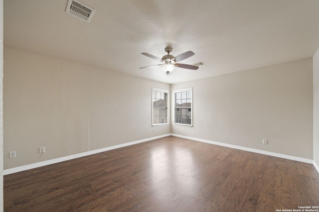 unfurnished room featuring ceiling fan, dark hardwood / wood-style floors, and a textured ceiling