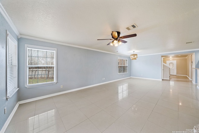 empty room with light tile patterned floors, crown molding, a textured ceiling, and ceiling fan