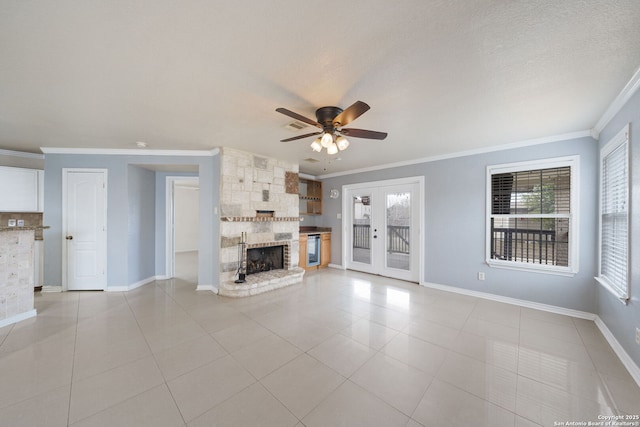 unfurnished living room featuring crown molding, a stone fireplace, and light tile patterned flooring