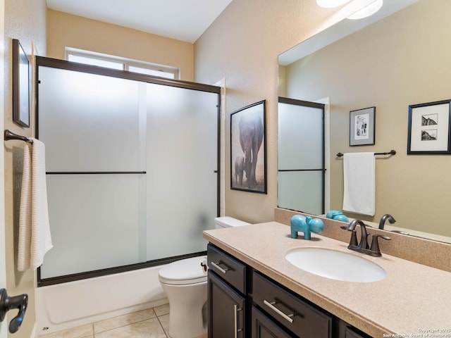 full bathroom with enclosed tub / shower combo, tile patterned floors, toilet, and vanity