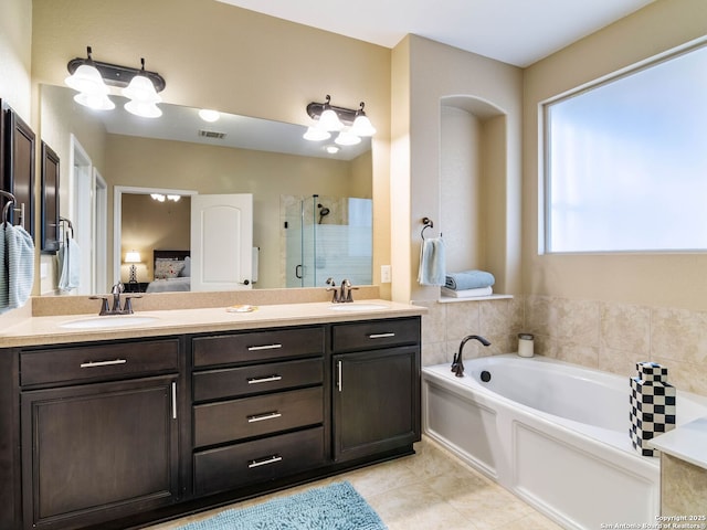 bathroom with vanity, tile patterned flooring, and shower with separate bathtub