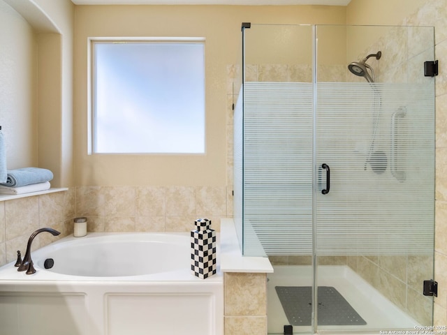 bathroom with separate shower and tub