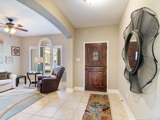 tiled entrance foyer featuring ceiling fan