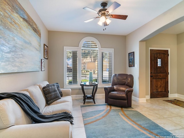 tiled living room with ceiling fan