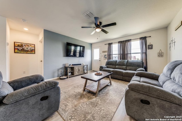 living room with ceiling fan and light hardwood / wood-style floors