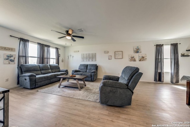 living room with ceiling fan and light hardwood / wood-style floors