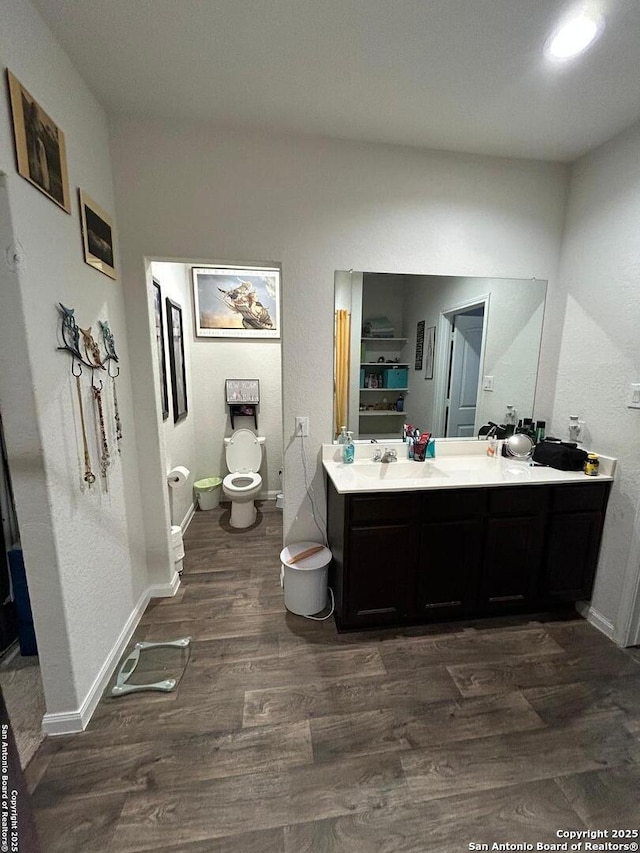 bathroom featuring vanity, hardwood / wood-style floors, and toilet