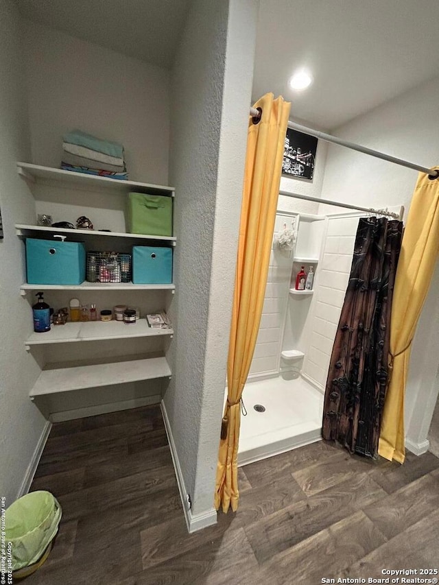 bathroom featuring hardwood / wood-style flooring and a shower with shower curtain