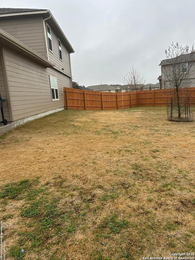 view of yard with a fenced backyard