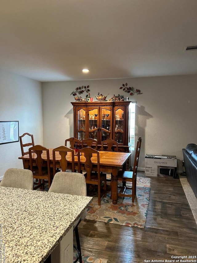 dining area featuring dark hardwood / wood-style floors