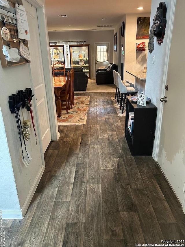 corridor featuring dark wood-type flooring