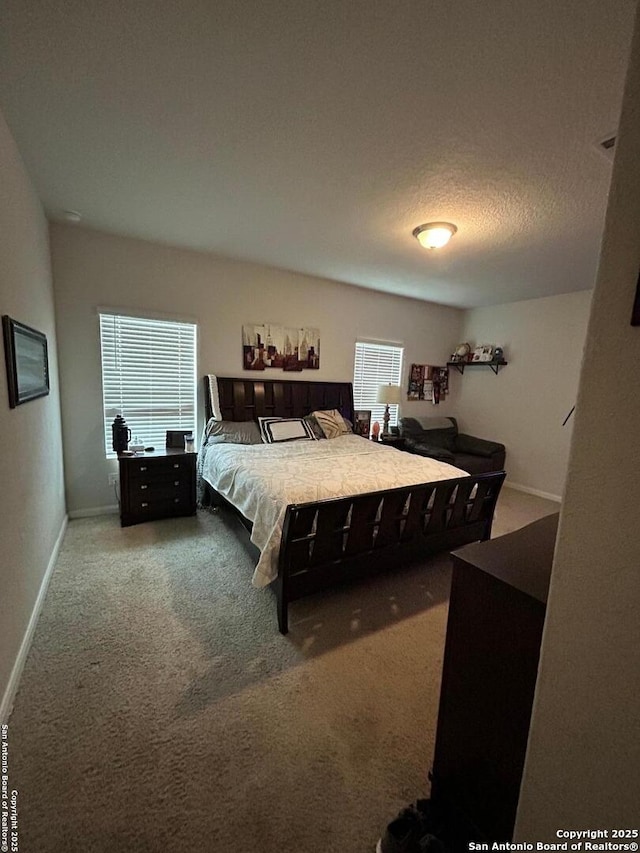 carpeted bedroom featuring a textured ceiling