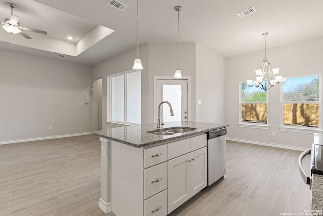 kitchen with sink, dark stone countertops, white cabinets, a center island with sink, and stainless steel dishwasher