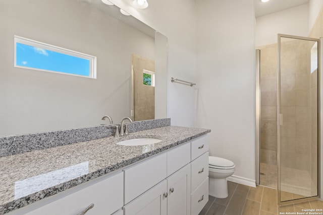 bathroom featuring walk in shower, vanity, and toilet