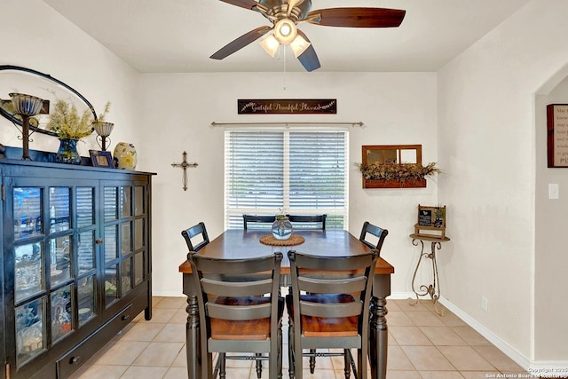 tiled dining space with ceiling fan