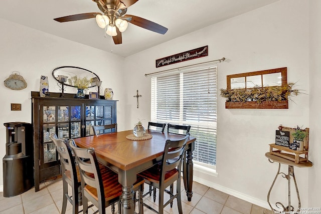 dining space with light tile patterned floors and ceiling fan