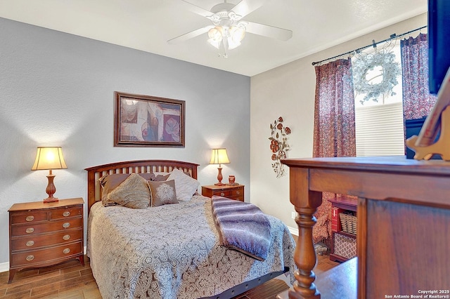 bedroom with wood-type flooring and ceiling fan