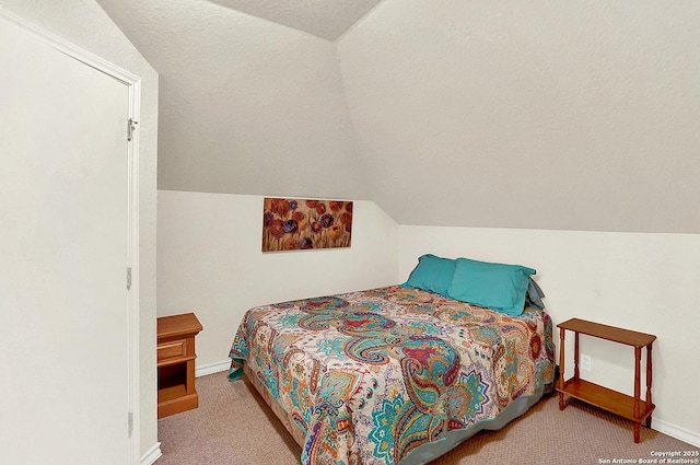 bedroom with light carpet, lofted ceiling, and a textured ceiling