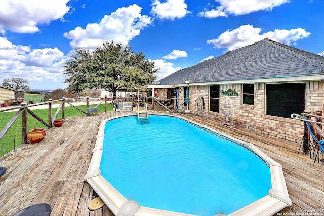 view of swimming pool with a wooden deck
