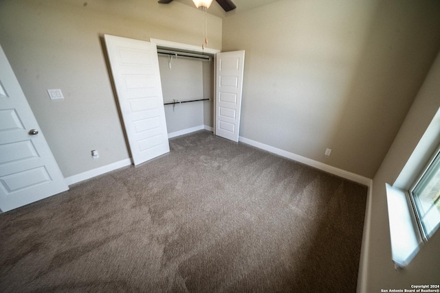 unfurnished bedroom featuring ceiling fan, a closet, and carpet