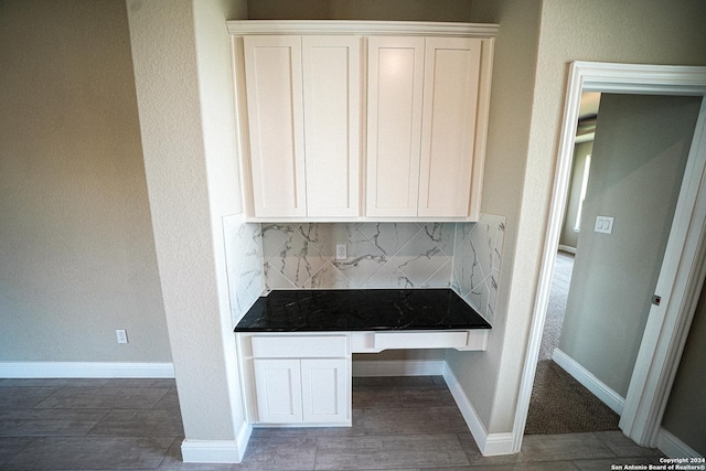 interior space featuring white cabinetry and tasteful backsplash