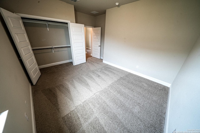 unfurnished bedroom with carpet floors and a closet