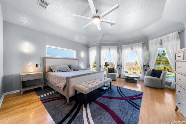 bedroom with light wood finished floors, access to outside, visible vents, and ceiling fan