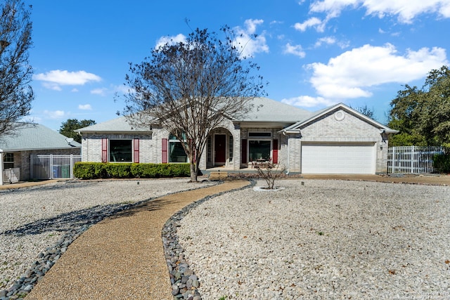 ranch-style house with brick siding, fence, and an attached garage