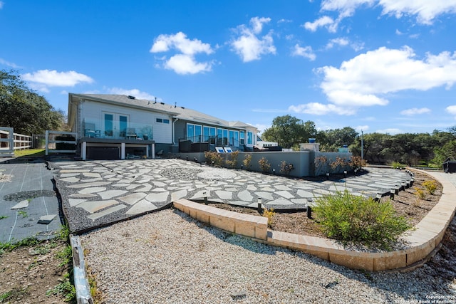 rear view of property featuring fence