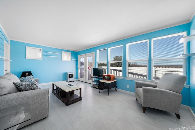 living area with french doors and baseboards