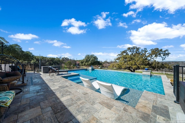 pool featuring an in ground hot tub, fence, and a patio