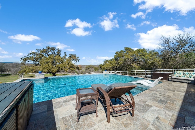 view of pool featuring fence, a fenced in pool, and a patio