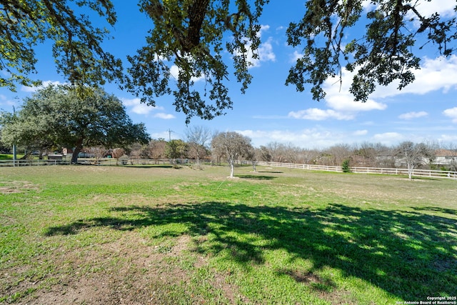 view of yard featuring a rural view and fence