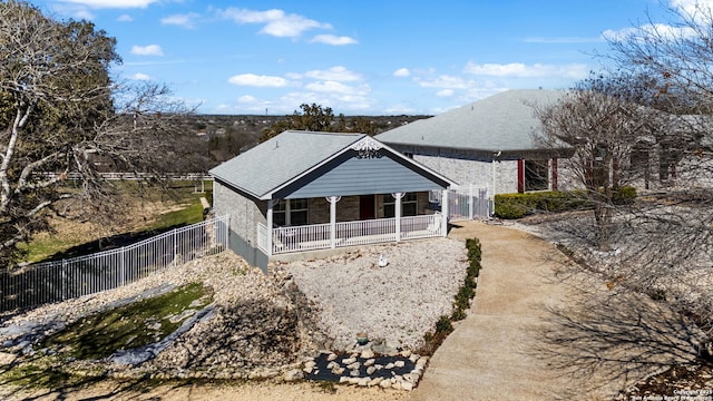 back of property with brick siding and fence