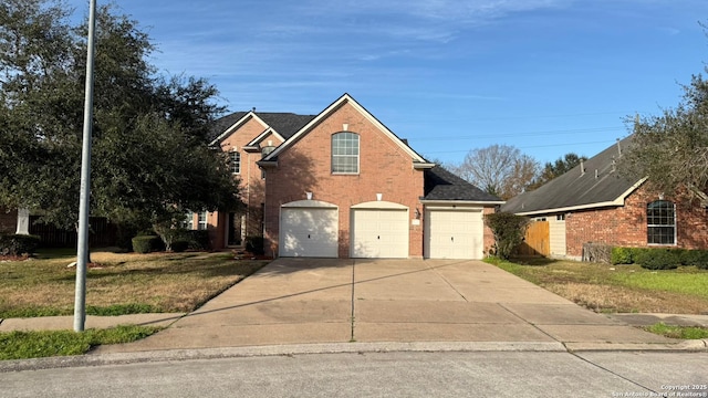 view of property with a garage and a front yard