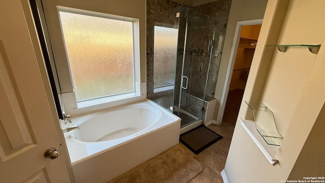 bathroom with tile patterned floors and independent shower and bath