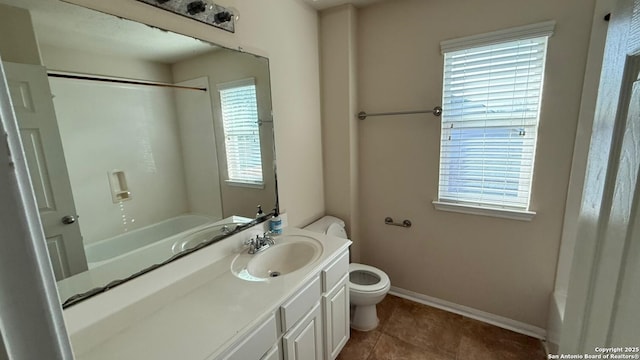 full bathroom with vanity, tile patterned floors, toilet, and washtub / shower combination