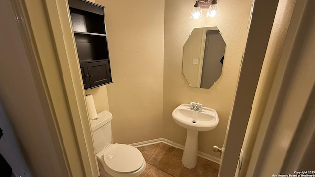 bathroom featuring tile patterned floors and toilet