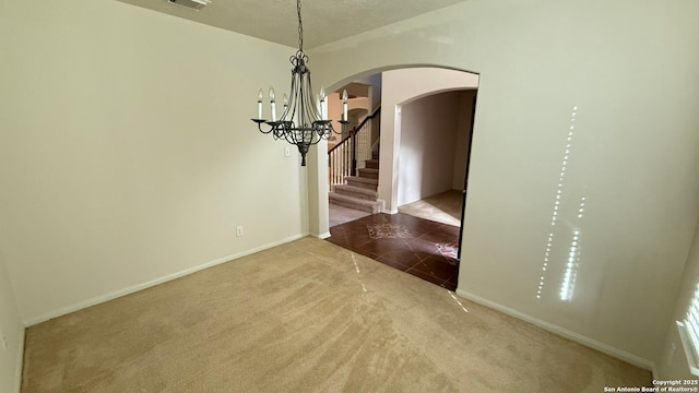 unfurnished dining area with an inviting chandelier and carpet floors