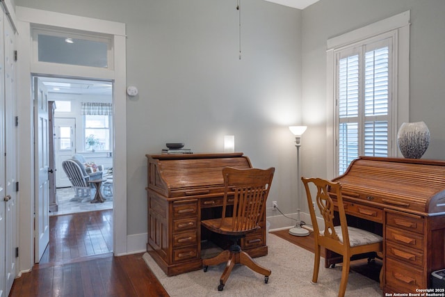 office with a healthy amount of sunlight and hardwood / wood-style floors