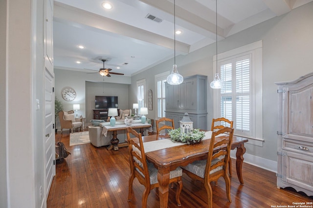 dining area featuring dark hardwood / wood-style flooring, ceiling fan, and beamed ceiling