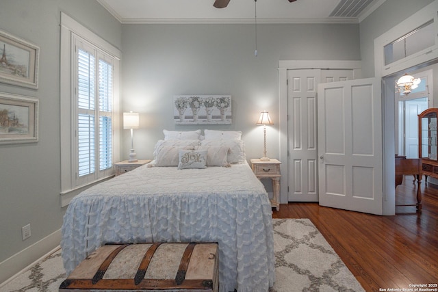 bedroom with hardwood / wood-style floors, ornamental molding, and ceiling fan