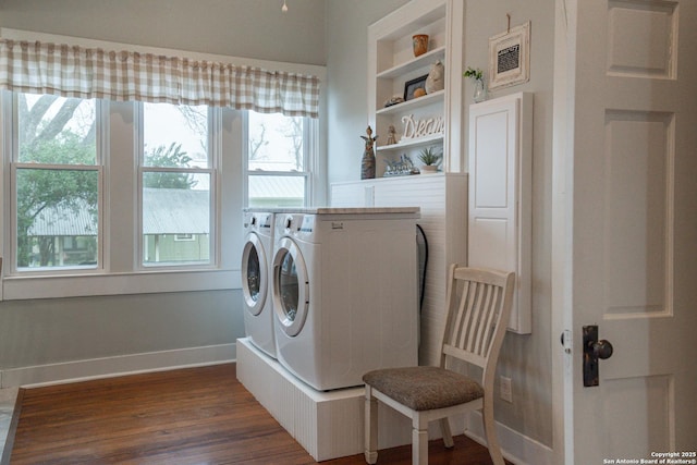 washroom featuring dark hardwood / wood-style flooring, built in features, and washing machine and dryer