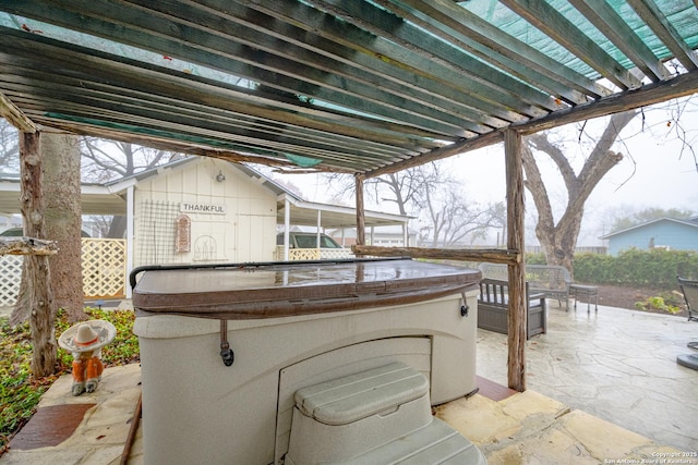 view of patio / terrace featuring a pergola and a hot tub