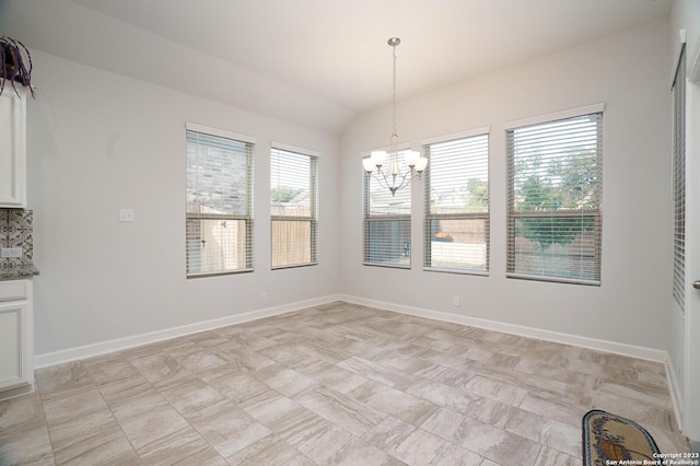 unfurnished dining area with lofted ceiling and a notable chandelier