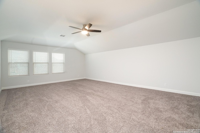 additional living space with carpet floors, vaulted ceiling, and ceiling fan